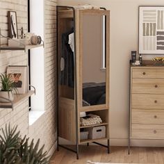 a bedroom with a dresser and mirror next to a brick wall