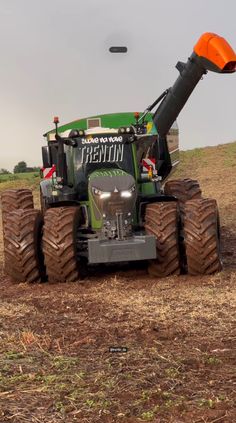 a tractor is driving in the dirt with an orange light on it's head