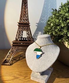 a necklace with the flag of south africa in front of the eiffel tower