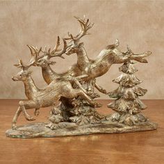 PRICES MAY VARY. Practicing their descent over some pine trees, the Reindeer Flight captivates the North Pole with their effortless skill. Bring this wondrous sight to your home for the holidays with this resin sculpture, finished in gold with gray washing and gold leaf embellishments. Measures 17"Wx5.5"Dx13"H. Holiday table sculpture Finished in gold Detailed with gold leaf Features flying reindeer Charming festive decor. Practicing their descent over some pine trees, the Reindeer Flight captiv Rimmed Plates, Silver Tablecloth, Christmas Dining Table Decor, Crystal Decorations, Table Sculpture, Flying Reindeer, Burlap Tablecloth, Red Napkins, Gold Reindeer