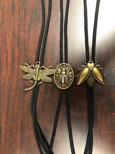 "Western Fly Bolo Tie, antique gold, Made in USA, Each Choose 36\" cord. Black Red Turquoise Olive Green handmade jewelry" Bolo Tie Aesthetic, Black Bolo Tie With Adjustable Cord, Gold Western Bolo Tie, Black Adjustable Bolo Tie, Adjustable Black Bolo Tie, Vintage Bolo Tie, Bolo Tie Outfit, Bolo Aesthetic