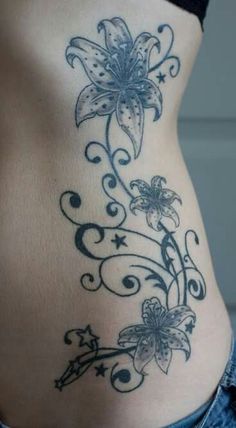 a woman's stomach with flowers and stars on it