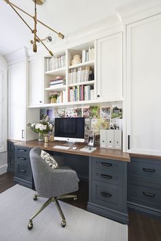 a home office with built - in bookshelves, desk and chair is shown