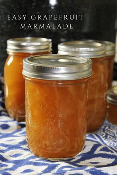 homemade grapefruit marmalade in jars on a blue and white tablecloth