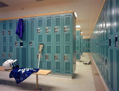 lockers with lacrosse helmets and umbrellas are lined up