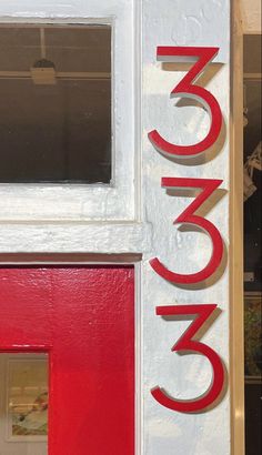 a red and white door with the word canon painted on it's front side