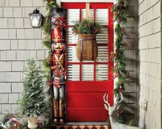 a red front door decorated with christmas decorations