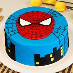 a spiderman cake is sitting on a plate