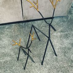 three black and gold decorative items on the floor