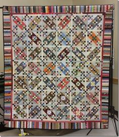 a quilt made with different colored strips