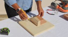 a person is working with wood on a table