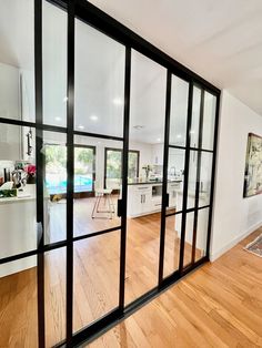 an open living room and kitchen area with sliding glass doors