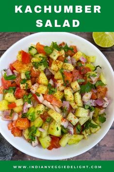 a white bowl filled with chopped vegetables and garnished with cilantro, red onion