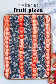 an american flag cake with strawberries and blueberries in the middle on a baking sheet