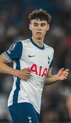 a young man is playing soccer on the field