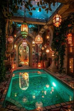 an indoor swimming pool surrounded by plants and lanterns