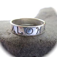 READY TO SHIP Hand Stamped Aloha Ring~ Send a gift of love, let your loved one know they are loved with this ALOHA ring. Custom made for you, each ring is hand forged with sterling silver and polished to a beautiful shine. Great gift for the sweetheart in your life! *This listing is for 1 hand stamped ALOHA ring made with sterling silver 4mm. X 1mm.* Each ring is a one of a kind and will vary. Shop~ http://www.etsy.com/shop/HanaMauiCreations?ref=si_shop International buyers please read our shipp Unique Adjustable Engraved Ring For Gift, Unique Hand Stamped Ring As Gift, Unique Hand Stamped Rings As A Gift, Unique Hand Stamped Rings As Gift, Symbolic Engraved Nickel-free Ring As Gift, Unique Stamped Engraved Ring As Gift, Unique Engraved Ring As Gift, Symbolic Nickel-free Engraved Ring Gift, Unique Personalized Engraved Ring As Gift