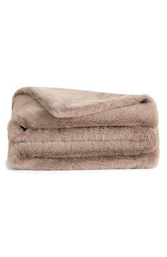 two blankets that are folded together on top of each other, one is brown and the other is beige