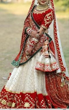 a woman in a red and white bridal outfit