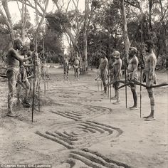 an old black and white photo of some people in the woods with numbers drawn on them