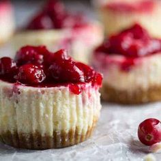 small cheesecakes with cranberry sauce on top