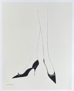 two pairs of high heeled shoes hanging from strings in front of a white background