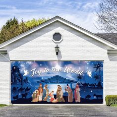 a garage door decorated with an image of the birth of jesus and three wise men