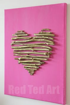 a heart made out of nails on a pink canvas