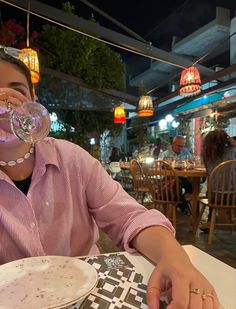 a woman sitting at a table in front of a plate with a bubble coming out of her mouth