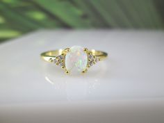 Oh my goodness....a beautiful 14kt. gold over 925 sterling silver oval opal ring with sparkling CZ side stones. The two stones go so well together, the look is just fabulous! The gorgeous fiery lab opal measures 8mm long, and the ring comes in various ring sizes. Rich and elegant. Stamped 925. KEEP*IN*TOUCH Please LIKE and FOLLOW us on www.facebook.com/vintageturquoiseandmore www.instagram.com@vintageturquoiseandmore Thank you for visiting our shop! Kimberly Johnson, Oval Opal Ring, Sterling Silver Opal Ring, Gold Opal Ring, Silver Opal Ring, Simulated Diamond Rings, Jewelry Opal, Opal Ring Gold, Ring Opal