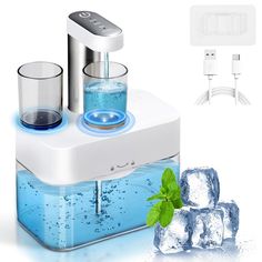 an electric ice maker with two glasses and mint on the counter top next to it