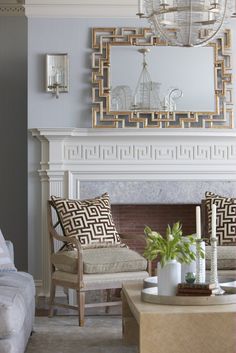 a living room filled with furniture and a fire place in front of a white fireplace