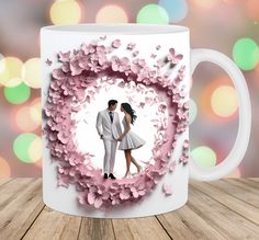 a coffee mug with a photo of two people in a heart surrounded by pink flowers