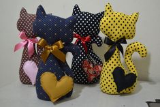 several small stuffed animals are lined up on a table together, with polka dots and hearts