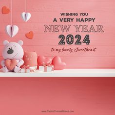 a teddy bear sitting on top of a table next to hearts and presents with the words wishing you a very happy new year