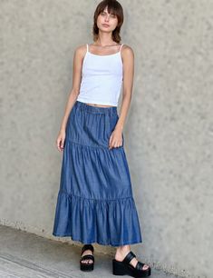 Ultra-light, ultra-soft, ultra-flowy, and ultra cute! The Flounce Denim Maxi Skirt from Billy T, with layered, pleated construction in a fun-and-flattering cut. The cover model is 5'7" wearing size small Fabric: 100% Tencel Length: 35" from waistband to longest point Blue Maxi Skirt, Billy T, Denim Maxi, Denim Maxi Skirt, Long Skirts, Cover Model, Double Trouble, Premium Denim, Style Board