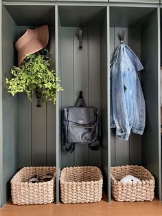 a coat rack with two baskets and a jacket hanging on the wall