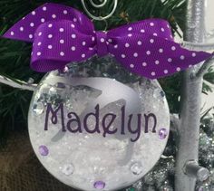 a personalized ornament hanging from a christmas tree