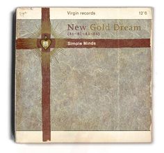 an old book with a cross on the front and brown ribbon around it, which reads new gold dream simple minds