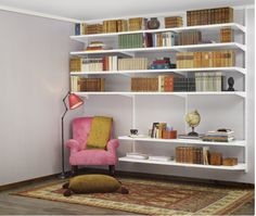 a pink chair sitting on top of a rug in front of a book shelf filled with books