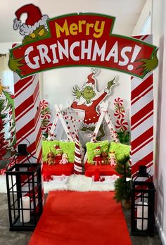 the grinch christmas decorations are on display in front of a red carpeted entrance