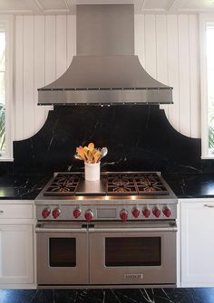 a stove top oven sitting inside of a kitchen next to a counter with two burners