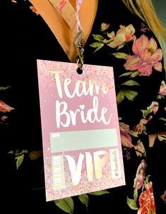 a badge that says team bride with flowers around it and a name tag attached to it