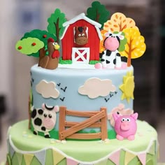 a colorful cake with farm animals on it