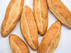 several loaves of bread on a white surface