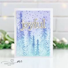 a card with the word joyful written in white and blue on top of it