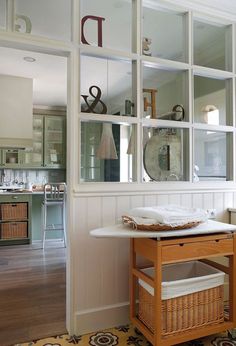 an image of a kitchen with white walls and wood flooring on the phone screen