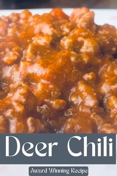 a close up of food on a plate with the words deer chili in front of it