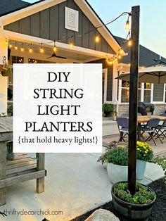 an outdoor patio with string lights and potted plants on the table in front of it