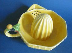 a yellow ceramic bowl with a shell in it